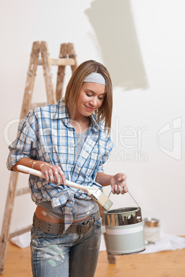 Home improvement: Smiling woman with paint