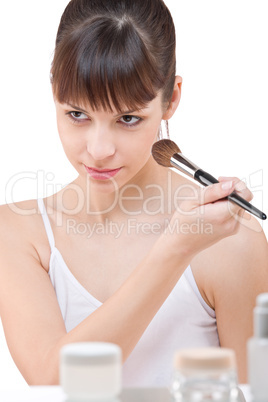 Body care: Young woman applying powder