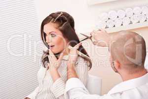 Professional hairdresser cut with scissors at salon