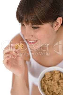 Female teenager eat healthy cereal for breakfast