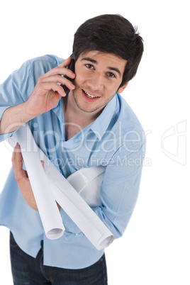 Male architect student with helmet and plans calling