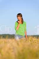 Young woman in sunset corn field