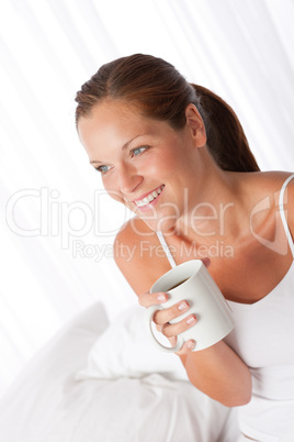 Beautiful young woman holding cup of coffee