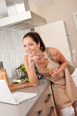 Woman with laptop in the kitchen