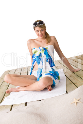 Beach - woman sunbathing with pareo and sunglasses