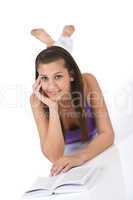 Happy teenager woman with book lying down