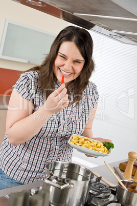 Cook - plus size smiling woman with chili pepper and tortellini