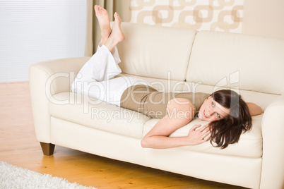 Young woman relax lying down on sofa