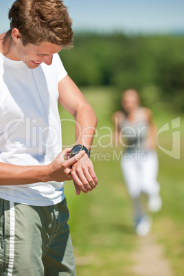 Young couple jogging outdoors in spring nature