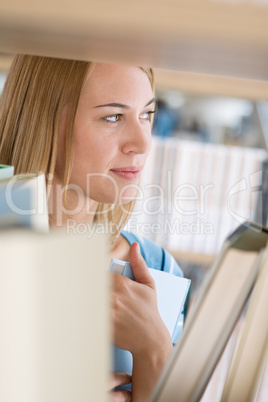 Student in library - happy woman hold book