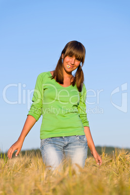 Young woman in sunset corn field