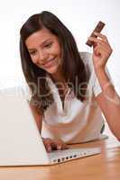 Happy teenager with laptop holding chocolate bar