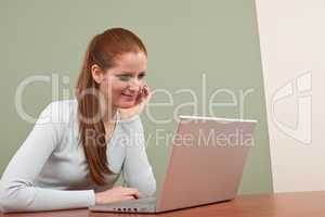 Long red hair  business woman with laptop