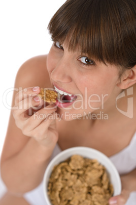 Female teenager eat healthy cereal for breakfast