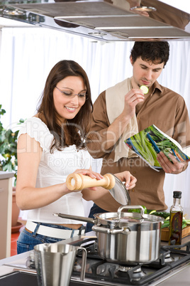 Happy couple cook together in modern kitchen