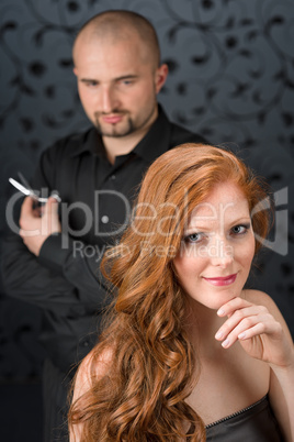 Professional hairdresser with fashion model at luxury salon