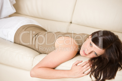 Young woman relax lying down on sofa