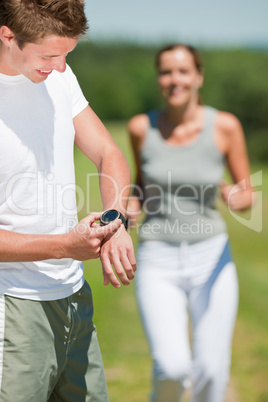 Young couple jogging outdoors in spring nature