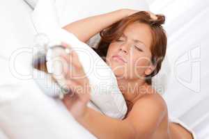 White lounge - Young woman holding alarm clock