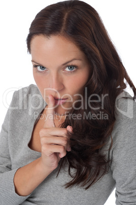 Beautiful woman expressing silence, finger on lips