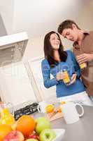 Young man and woman drinking orange juice