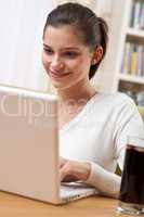 Students - Happy teenager with laptop sitting on armchair