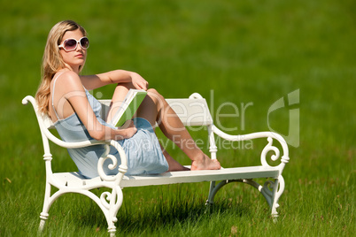 Spring and summer - Young woman relaxing in meadow