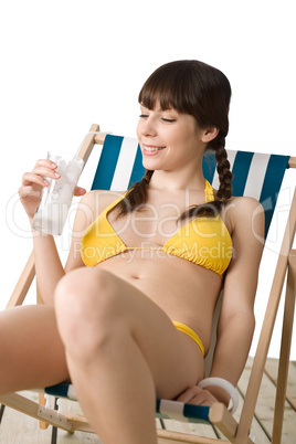 Beach - Woman in bikini with cold drink sunbathing