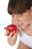Female teenager eat red apple
