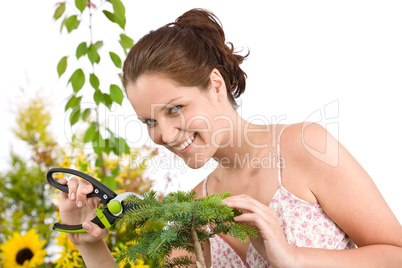 Gardening - woman cutting tree with shears