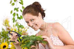 Gardening - woman cutting tree with shears