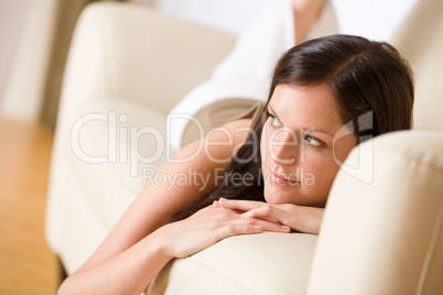 Young woman relax lying down on sofa