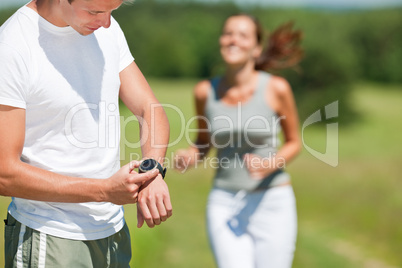 Young couple jogging outdoors in spring nature