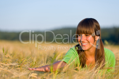 Happy woman in sunset corn field enjoy sun