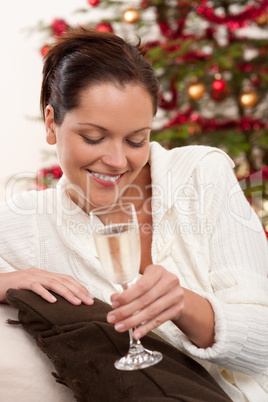 Attractive brown hair woman in front of Christmas tree