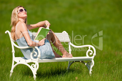 Spring and summer - Young woman relaxing in meadow