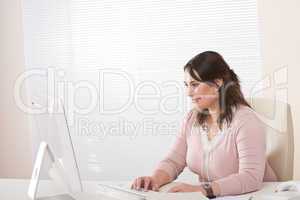 Young female executive working with computer at office