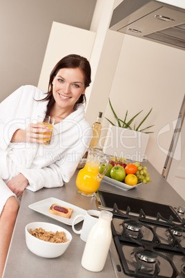 Young woman having breakfast in modern kitchen