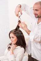 Professional hairdresser cut with scissors at salon