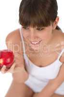 Female teenager eat apple for breakfast