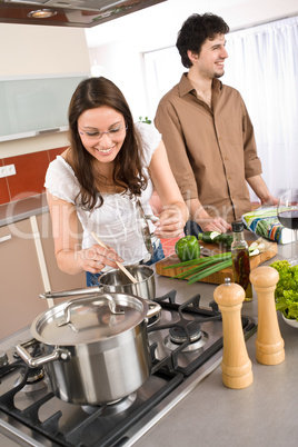 Young couple cooking together in modern kitchen