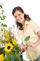 Gardening - woman with sunflower and pruning shears