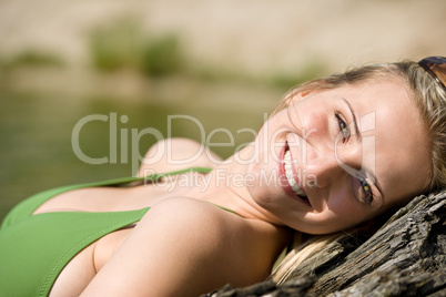 Blond woman relax in bikini at lake