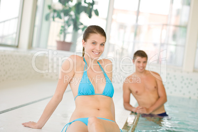Swimming pool - young beautiful woman relax in bikini