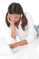 Teenager lying down with laptop