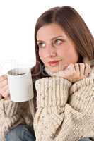 Winter portrait of happy woman holding cup of coffee