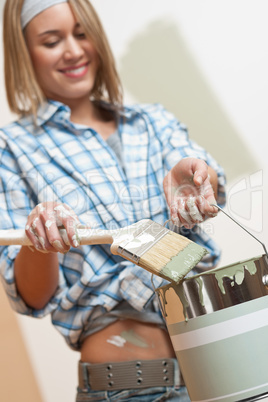 Home improvement: Smiling woman holding paint can