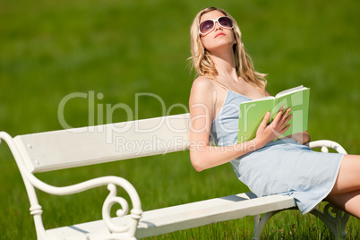 Spring and summer - Young woman relaxing in meadow