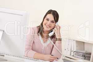 Young secretary on phone at modern office