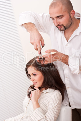 Professional hairdresser cut with scissors at salon